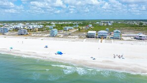 A coastal area with beachfront properties, a sandy beach, and ocean waves. - ☀️ Rhapsody in Blues - 2 Decks - Steps to the Beach - Pet Friendly 🌴 (Mexico Beach)