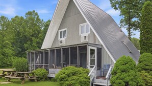 A house with a sloped roof, large windows, and a porch.