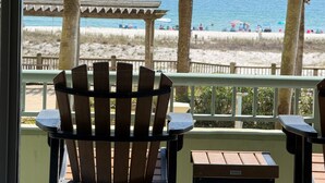 A wooden chair and table on a balcony with a view of the beach and ocean. - Beach Club Avalon 206 K/Q/ Tw-Tw Bunk/SS Sleeps 8 - Beach View- Pools (Gulf Shores)