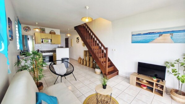 A spacious living area with a staircase, a dining area, and a kitchen. - 3-Bedroom Apartment with Stunning Panoramic Ocean Views - Terraces & BBQ, Sainte-Luce (Sainte-Luce)