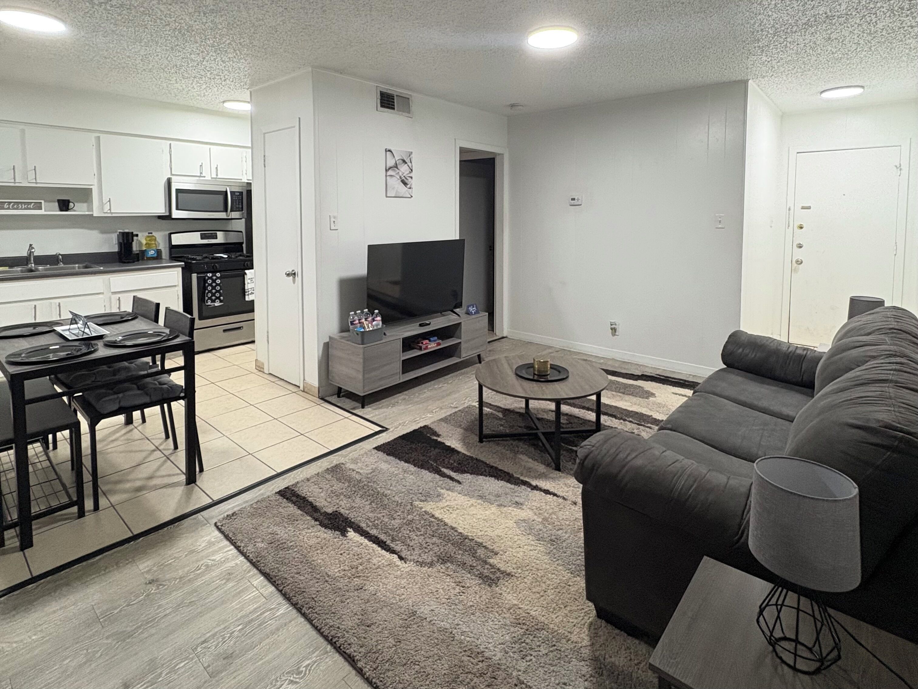 A modern living room with a sofa, coffee table, and TV.