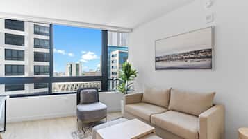 Apartment, City View | Living area | 50-inch Smart TV with cable channels