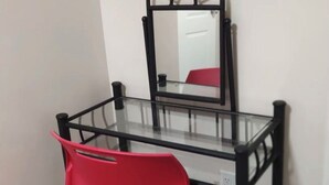 A glass-top table with a black metal frame, a red chair, and a mirror on the wall. - Fully Private Unit in Heart of Scarborough with Private Kitchen (Toronto)