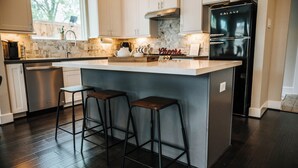 A kitchen with a large island, bar stools, a refrigerator, and a window. - Stay in the Heart of Houston, 5' to Downtown, close Medical Center & World Cup (Houston)
