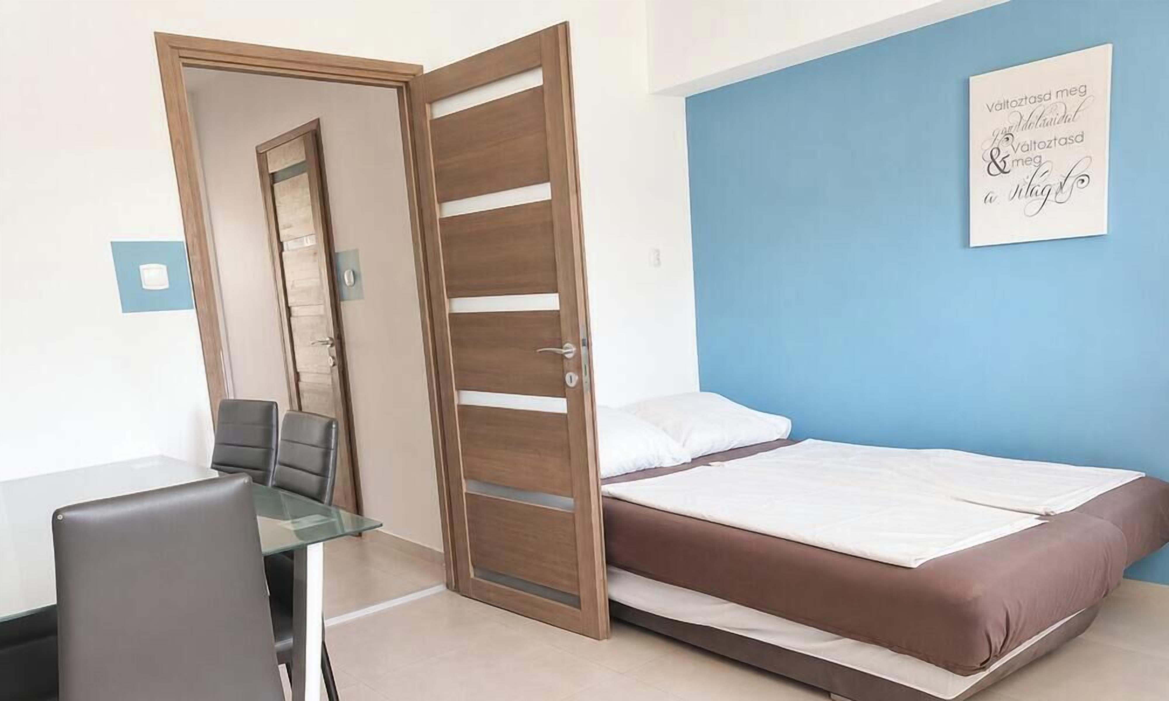 A room with a bed, a desk, and a chair.