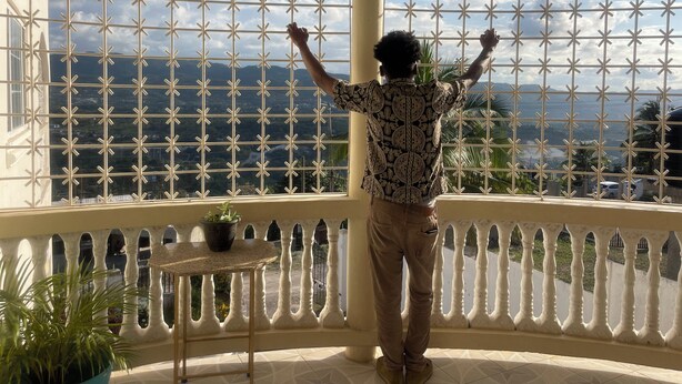 A person standing on a balcony with a view of a mountainous landscape. - Golden Eagle/ jacuzzi/WIFI/ 20 min Airport & Beach (Montego Bay)