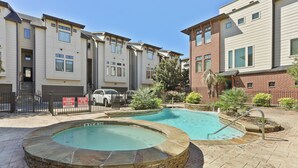 A residential building with a swimming pool and a hot tub. - Cozy 3 bed 3 bath townhome with pool & hut tub.  Best location in Houston! (Houston)