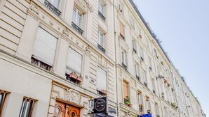 A multi-story building with a classic architectural style, featuring ornate balconies and a series of windows. - APPARTEMENT PARIS 10eme CANAL ST MARTIN (Paris)