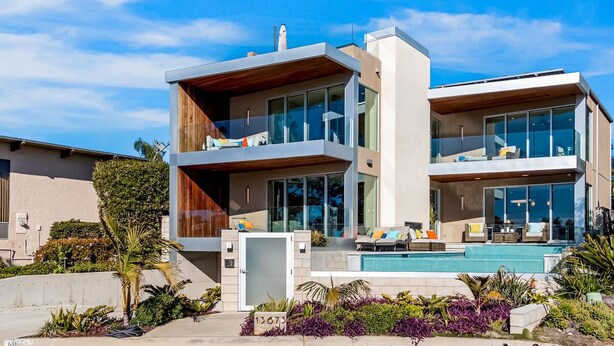 A modern two-story house with a swimming pool, large windows, and a well-maintained garden.