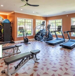 A gym with treadmills, elliptical machines, and a bench. - 2-bedroom 1 bath apartment in Lewisville (Lewisville)