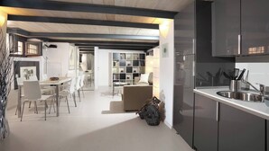 A modern interior with a dining area, kitchen, and living space. - Manray Charming and Modern Ground Floor Loft (Rome)