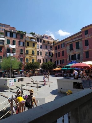 A multi-story building with balconies and a courtyard. - Scarella room (Vernazza)
