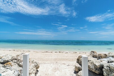 Peaceful 2BR Retreat ~ Private Sandy Beach ~ Heated Pool ~ 1st FL