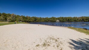 A sandy beach with a lake, trees, and a small structure in the distance. - Hot Tub*Sauna*Pool Table*Air Hockey*King Bed*Deck (Blakeslee)