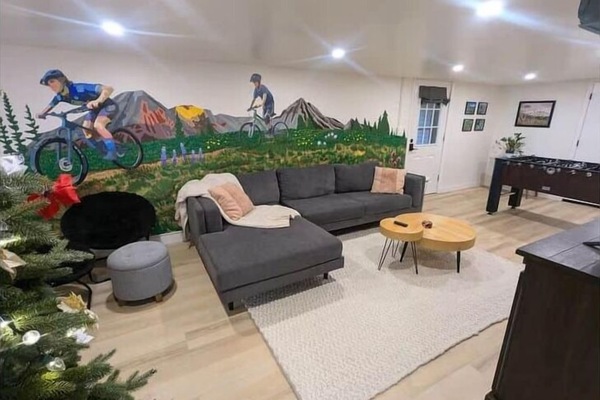 Parker's Den living room with custom mural