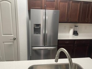 A stainless steel refrigerator with a water and ice dispenser, a built-in ice maker, and a freezer compartment. - Convenient Spacious 2Bed/2Bath (Frisco)