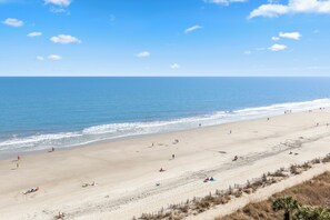 A wide beach with a clear sky, calm sea, and a few people. - Direct Oceanfront Views 2BR 2B Condo Private Balcony Sleeps 6 (Myrtle Beach)