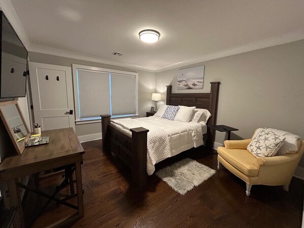 A bedroom with a bed, bedside table, chair, and a window with blinds. - Luxury Coastal Retreat ✨ 5 min to Beach,Sleeps 10,BBQ + Patio (Long Branch)