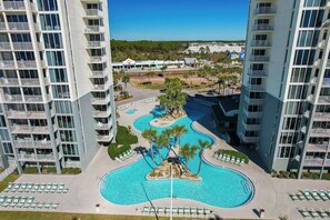 A hotel with a large pool, multiple balconies, and a view of the surrounding area. - 2BR Beachfront Condo Long Beach Resort 6th Floor On Site Snack Bar (Panama City Beach)