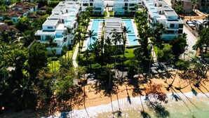 A resort with multiple buildings, a swimming pool, and a beach. - 2BR Partial Ocean View on Beach | Sol de Arena A5 (Las Terrenas)