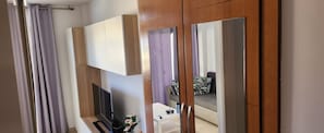 A modern bathroom with a shower, toilet, and sink. - English Beach: Apartment next to the Ocean. (San Bartolomé de Tirajana)