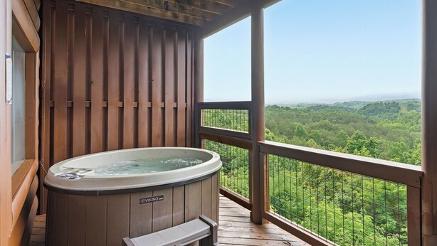 A wooden deck with a hot tub and a view of a forested landscape. - Million Dollar Majestic View with best views around!!!! (Sevierville)