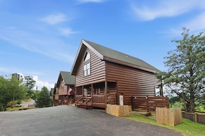 A log cabin-style building with a porch, a flag, and a wooden fence. - Million Dollar Majestic View with best views around!!!! (Sevierville)