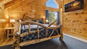 A log cabin bedroom with a bed, a window, and a painting on the wall. - Million Dollar Majestic View with best views around!!!! (Sevierville)