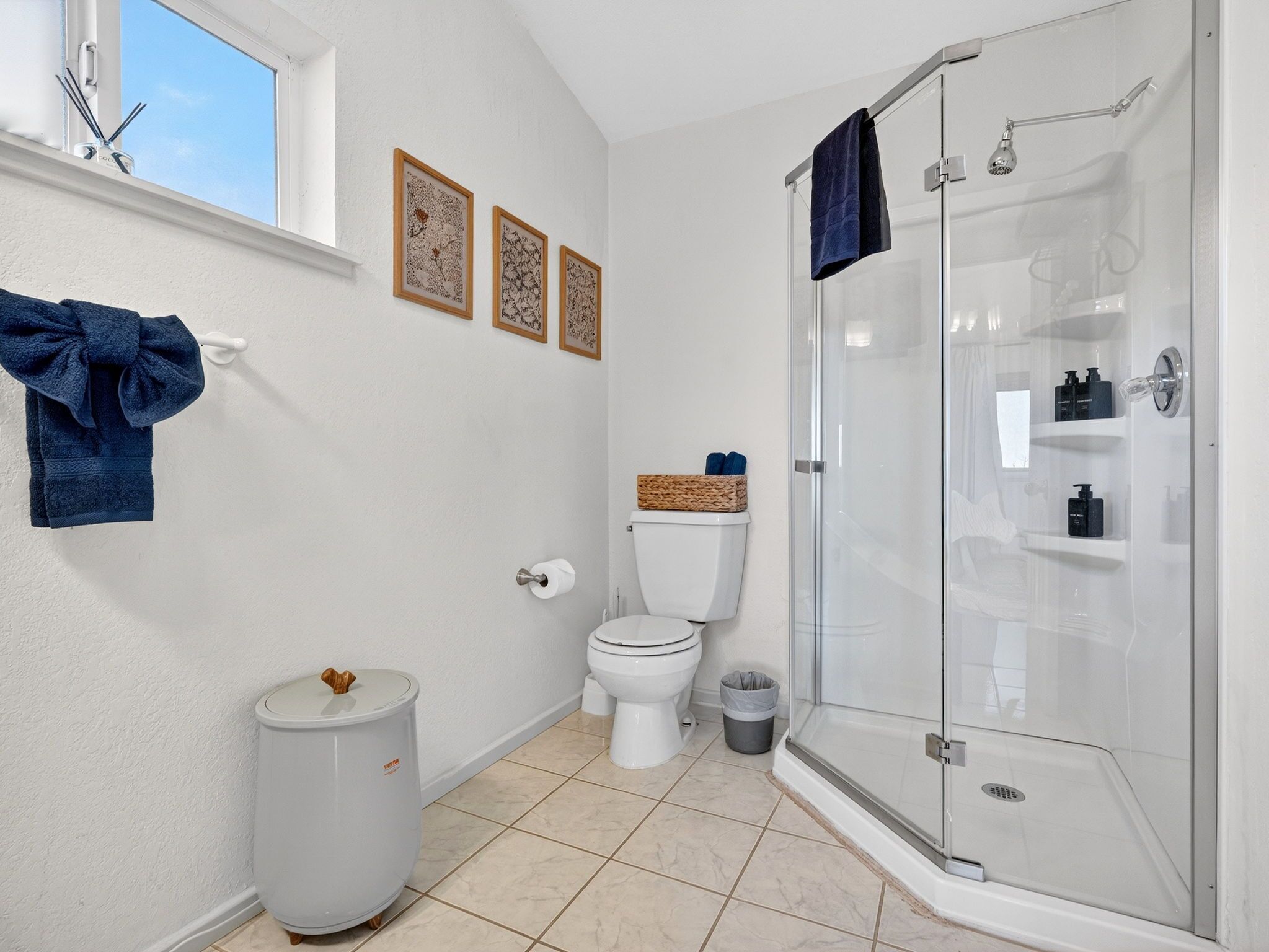 A bathroom with a toilet, bidet, and a glass-enclosed shower.