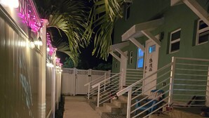 A gated entrance with a concrete pathway leading to a staircase. - Cozy Studio Centrally located in Grand Cayman near beaches,shops,and restaurants (Bodden Town)