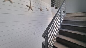 A staircase with a metal railing and wooden steps. - Cozy Studio Centrally located in Grand Cayman near beaches,shops,and restaurants (Bodden Town)