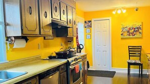 A kitchen with wooden cabinets, a stove, and a sink. - Cozy House located close Skylon Towery, Falls view Casino & Horseshoe Falls (Niagara Falls)