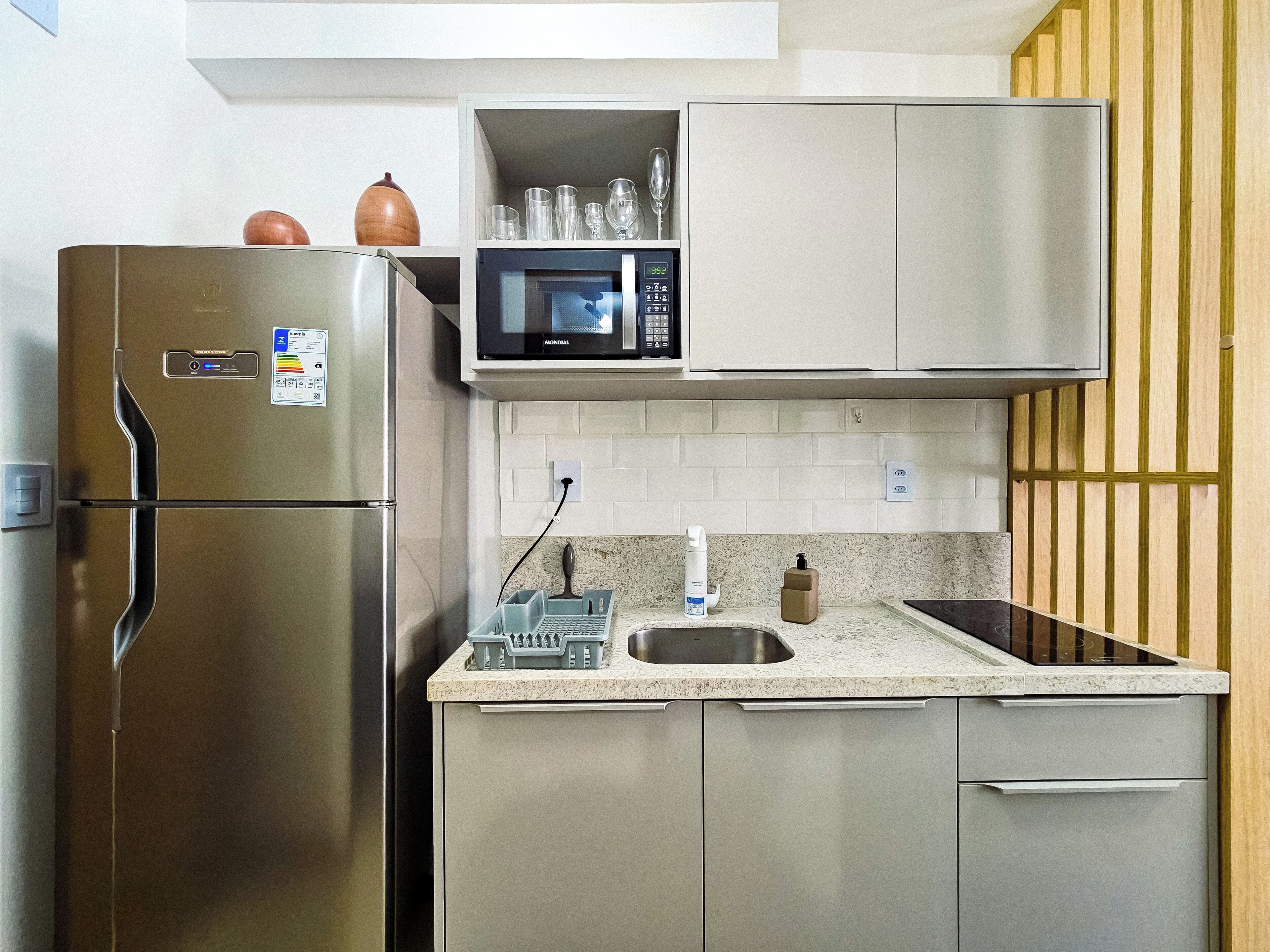 A kitchen with stainless steel appliances, a microwave, and a sink.