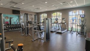 A gym with cardio machines, weight stations, and dumbbells. - Resort Home, Private Pool and Spa, Outdoor Theater (Kissimmee)