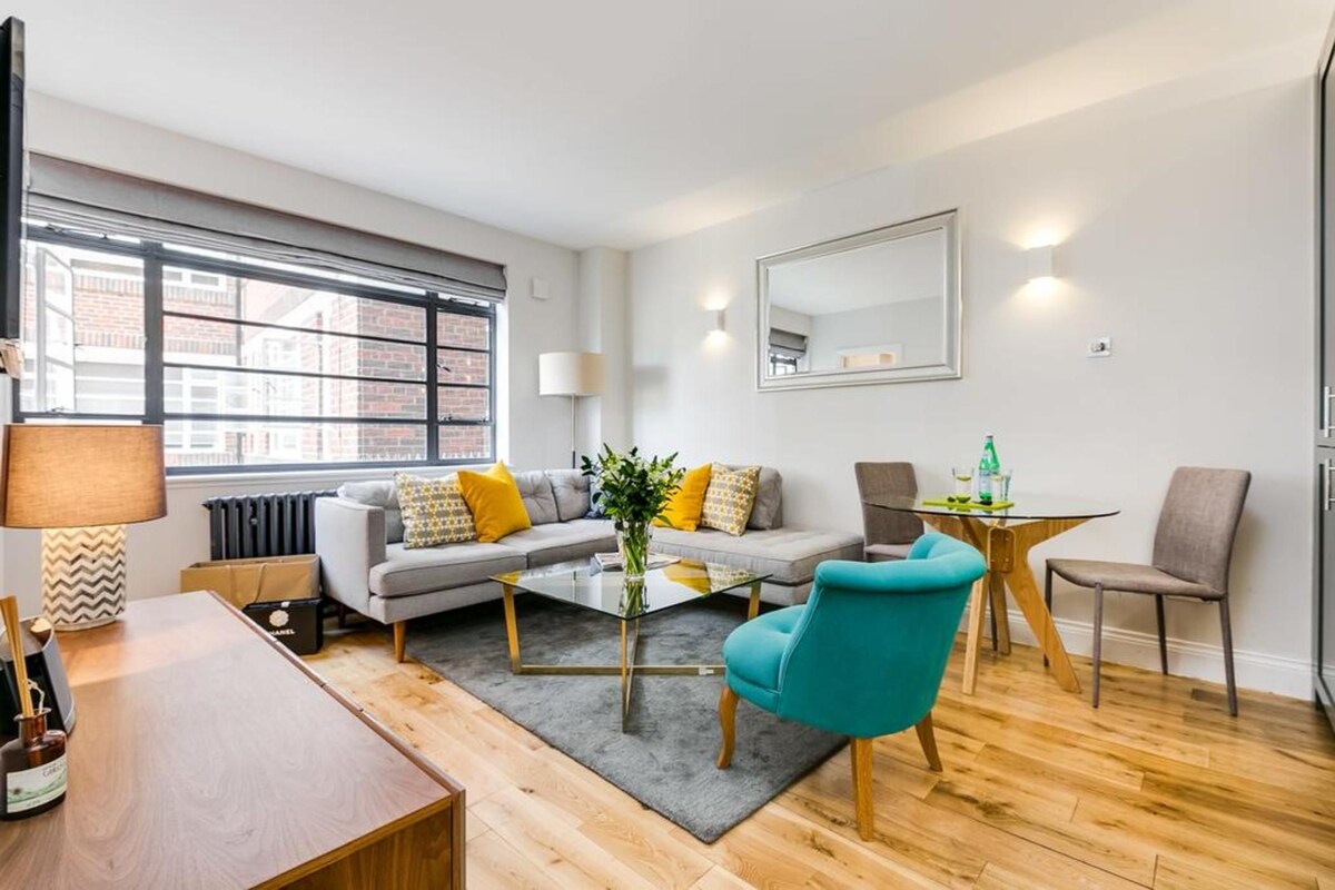 A modern living room with a sofa, coffee table, and chairs.