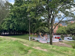A park with playground equipment, benches, and a grassy area. - w* | Distinct Loft in the Heart of Bogotá (Bogotá)