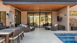 An outdoor patio with a pool, wicker furniture, and a ceiling fan. - Luxury NEW home Built 2024-Pool-Sedona Red Rock Views (Sedona)