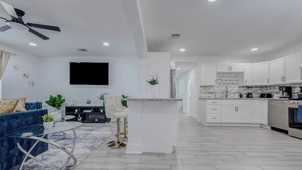 A modern kitchen with white cabinets, a central island, and a built-in oven. - Beautiful Luxury Retreat in Downtown Houston minutes to NRG/UT/Med Ctr/Zoo/ UH (Houston)