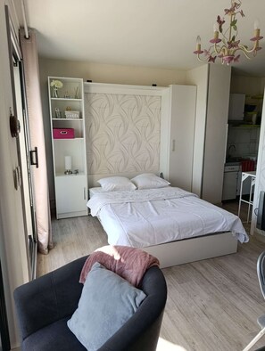A bedroom with a bed, a wardrobe, a desk, and a chair. - Sea-view studio by the port | 2 guests | Ref 2000 (ST CAST LE GUILDO)
