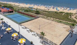 A beach tennis court with adjacent outdoor seating and a view of the beach. - Stunning Ocean View Studio at the Golden Sands (Ocean City)