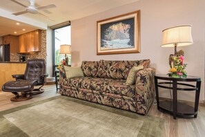 A living room with a sofa, a recliner, a lamp, and a painting on the wall. - Mahana Villas | Oceanfront 6 BR Sleeps 19 | Car Incl. w/ 6+ Nights | MAH ML-3885 by KBM (Lahaina)