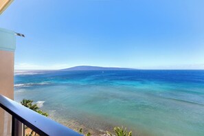 A clear view of the ocean from a balcony with a distant mountain and a clear sky. - Mahana Villas | Oceanfront 7 BR Sleeps 21 | Car Incl. w/ 6+ Nights | MAH ML-3890 by KBM (Lahaina)