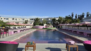 A pool area with lounge chairs, umbrellas, and a clear sky. - Le Jardin d'Eden JE112 - Suite Junior PMR Luxe - 2 people (AGDE)