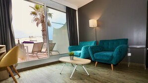 Un salon moderne avec un canapé de couleur turquoise, une table basse ronde et un lampadaire.