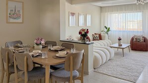 A dining area with a round table, chairs, and a sofa. - The Overlook Tangier - Panoramic Sea and Kasbah View Downtown (Tanger)