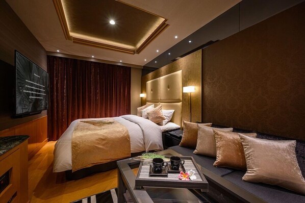 A hotel room with two beds, a sofa, a TV, and a tray table with items. - Hotel C.kohoku (Nishitokyo)