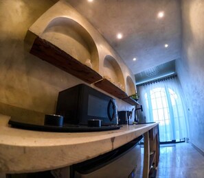 A kitchen with a marble countertop, a coffee machine, and a built-in oven. - Private Oasis Roof (Giza)