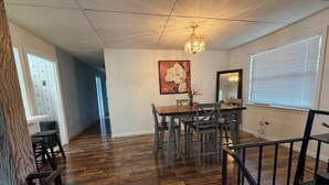 A dining area with a wooden table and chairs, a chandelier, and a painting on the wall. - Peaceful Hot Tub Hideaway - 15 mins to Chatt - Dog Friendly (Rossville)
