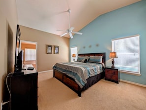 A bedroom with a bed, a desk, a chair, a ceiling fan, and two windows with blinds. - Sandy`s Sanctuary - Conservation View - South-West Facing Pool (Davenport)