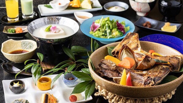 A variety of dishes and drinks on a table, including a bowl of grilled fish, a plate of vegetables, and several small bowls with sauces. - HOTEL nehako (Hakone)